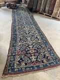 Antique 1920's Persian runner showing the end with the crimson wool woven into the design.