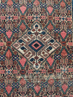 Close up view of handwoven Persian runner with earthy vintage vibe.