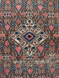 Close up view of handwoven Persian runner with earthy vintage vibe.