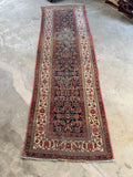 Vintage Persian Malayer runner featuring Herati design on a dark navy ground.