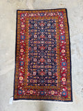 Persian scatter rug with repeating Herati design and plush wool pile.