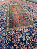 Vintage Persian scatter rug with distressed wool pile, handmade tribal floral carpet.