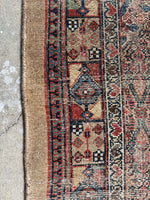 Close up of skinny 1920s Persian runner in low pile with scattered wear.