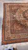 Low pile antique Persian rug showing scattered wear, beautiful age, character, and durable construction.
