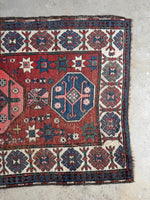 Antique runner with ram’s horn motifs for strength and protection.