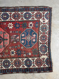 Antique runner with ram’s horn motifs for strength and protection.