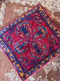 Antique Persian Bibikabad rug mat with central floral design in carmine red and turmeric yellow.