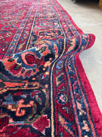 Persian rug glowing with ruby and floral tones.