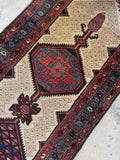 Tribal medallions and saturated color on antique runner.