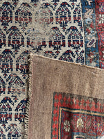 Underside view of vintage Seraband runner with low pile and scattered wear.