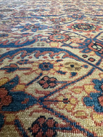 Detailed view of ornate rug border with navy and brick red accents.