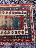 Distressed green Caucasian area rug in 4x6 accent size for low traffic areas.