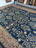 Large scale antique Turkish Sparta rug featuring a moody navy field and soft floral motifs.
