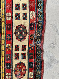 Antique runner close-up showing old repairs, reinforced edges and handmade patches.