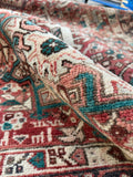 Mid century Persian wool runner rug with rich abrash and angular floral elements throughout the field.