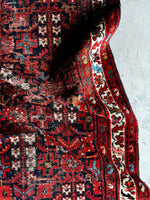 Close-up of handwoven vegetable-dyed Persian runner motifs.