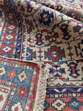 Underside view antique Caucasian Shirvan rug with tribal border motifs and durable wool foundation.
