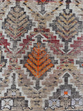 Vegetable dyed wool rug close-up texture shot highlighting rich abrash dye lots and worn fibers.