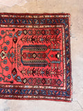 Antique blue and red Persian rug woven with vegetable dyed wool.