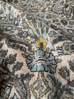 Ice blue and steel blue details on wheat-colored rug.