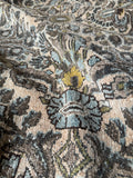 Ice blue and steel blue details on wheat-colored rug.