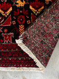 Vibrant small Persian rug 3x6 saturated red and black tribal wool pile with back showng weave