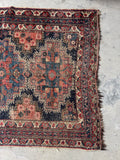 5x6 early 1900s Persian tribal area rug with worn texture, geometric drawing, and old rug character.