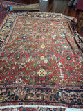 Antique Persian Mahal wool rug with vegetable dyed colors, floral design and authentic antique wear.
