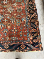Corner view of a durable Heriz rug with bold motifs