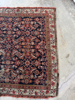 One end view of handwoven Persian rug dyed with natural plant and vegetable sources.