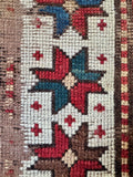 Close up of border motif on a hand knotted wool Kazak rug from Black and Caspian Sea mountain weavers.