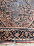 Muted terracotta Persian showing some scattered wear and timeworn character.
