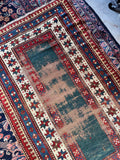Green antique tribal rug with multiple border bands, measuring 4 foot by 6 foot 6 inches.