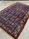 Vegetable-dyed Persian Kurdish rug in navy, coral, red, blue, green and ivory.