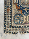 Corner detail showing age related wear on late 19th century Caucasian rug.