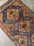 Antique Persian triple medallion rug showcasing distressed wool pile and time-worn character.